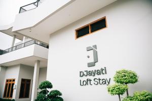 a white house with a sign that reads dixon lot stay at Djayati Loft Stay in Yogyakarta
