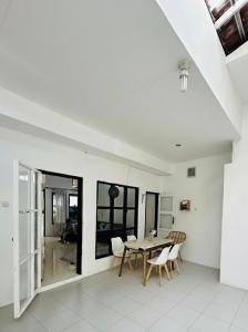 a dining room with a table and chairs at Spacious House - Ngemplak, Surakarta in Kadipiro