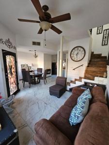 a living room with a couch and a clock on the wall at normahome in Zaragoza