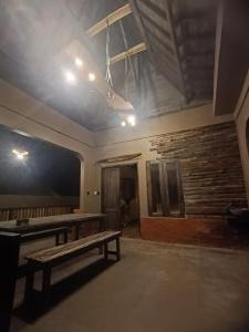 an empty room with a bench and a stone wall at Jagad Villa with 3 Bedroom in Ungasan