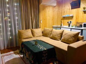 a living room with a couch with a table on it at Sunrise house merisi in Merisi