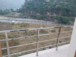 a view of a river from a balcony at Hotel Dharam Ganga in Uttarkāshi