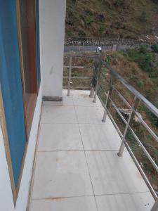 a balcony of a house with a fence at Hotel Dharam Ganga in Uttarkāshi