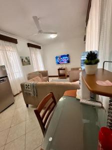 a living room with a couch and a table at 3Bedroom Villa-Shanzu, Mombasa in Mombasa