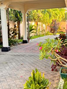 a brick walkway in a house with flowers and plants at 3Bedroom Villa-Shanzu, Mombasa in Mombasa