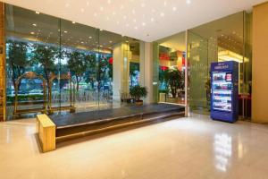 a store front with a bench in the middle of a building at Catic Hotel--Adjacent Buliding in Zhuhai