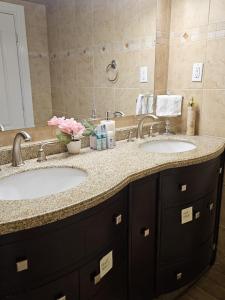 a bathroom with two sinks and a large mirror at 2 Bed, 1 Bath- Main floor, 2 Parking- Licensed in Oakville +23 photos