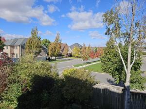 a street in a residential neighborhood with houses at 2 Bed, 1 Bath- Main floor, 2 Parking- Licensed in Oakville