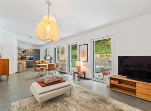 a living room with a couch and a tv and a table at Boho Chic Penthouse in Luxembourg