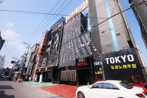 a white car parked in front of a toyota building at SU Motel in Gumi
