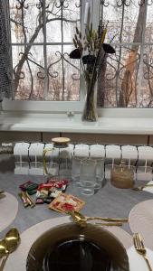 a dining table with a sink and a vase of flowers at Kurmangazy in Zhezdi +7 photos