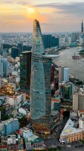 a tall glass skyscraper in a city with buildings at Saigon Quiet Stay in Ho Chi Minh City