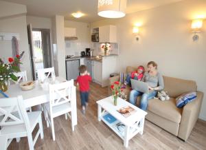 a woman and a child in a living room at Résidence Odalys Les Villas de la Baie in Le Crotoy