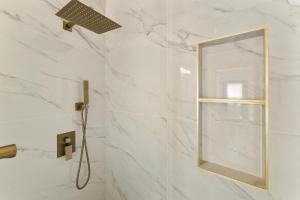 a bathroom with a shower with a mirror at Lyn's Stay in Westminster