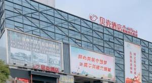 ein Gebäude mit Schildern an der Seite in der Unterkunft Shell Hotel Chuzhou Economic Development Zone Internation Shangcheng in Chuzhou