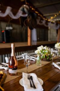 a bottle of beer sitting on a wooden table at Drovers Run B&B and Events Venue  +39 photos