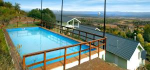 a large swimming pool on top of a hill at La Fleur in Villa General Belgrano