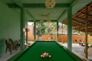 a pool table in the middle of a room at Social Stays in Negombo
