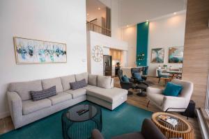 a living room with a couch and chairs at 407 - Luxury Condo - Incredible View & Pool in Baie-Saint-Paul +65 photos