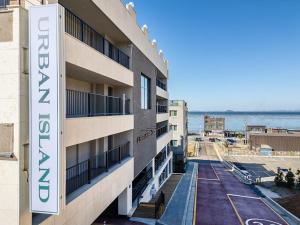 a view of a building with the ocean in the background at Daebudo Urban Island in Ansan