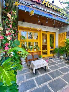 a patio with a table and chairs in front of a house at Bee Homestay Phan Thiết in Phan Thiet