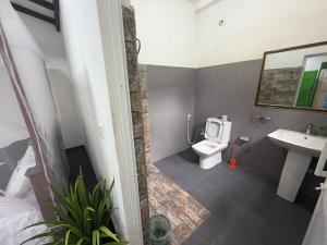 a bathroom with a toilet and a sink at Green Bird in Mirissa