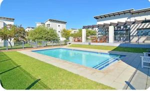 a swimming pool in the yard of a building at MANDITAZ STUDIO in Fourways