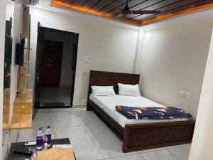 a bedroom with a bed in a room with a mirror at V guesthouse staycation in Bāpatla +5 photos