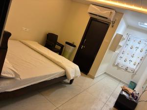 a bedroom with a bed and a door with a window at V guesthouse staycation in Bāpatla