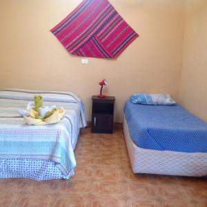 Postel nebo postele na pokoji v ubytování Hostal Tuyasto