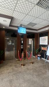 a room with red ropes and a sign on a ceiling at شموخ العلياء للشقق المخدومة in Al Jith