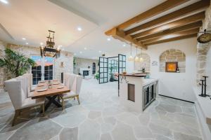a dining room with a table and chairs and a fireplace at Mintcello Estate in Malibu