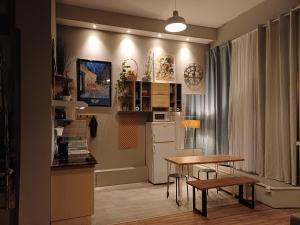 a small kitchen with a table and a kitchen with a refrigerator at Das Moritz- Self Check In in Plauen