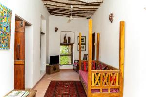 a room with a bedroom with a bed and a window at Ella's Swahili House in Bagamoyo