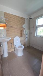 a bathroom with a toilet and a sink at Tapas in Champawat +47 photos