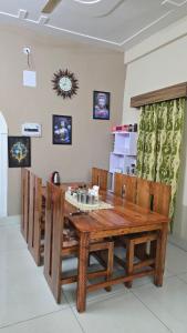 a wooden dining room table and chairs in a room at Tapas in Champawat