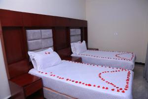 Ένα ή περισσότερα κρεβάτια σε δωμάτιο στο Yemata Hotel