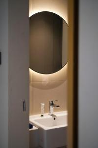 a bathroom with a sink and a mirror at Samai Suites in Bandar Lampung +12 photos