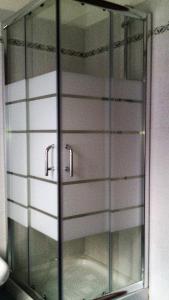 a glass cabinet with a mirror in a bathroom at Agriturismo Molino Nuovo in Castel San Pietro Terme