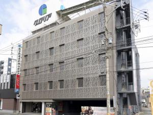 a building with aundai sign on the side of it at カプセルホテルグロリア in Beppu