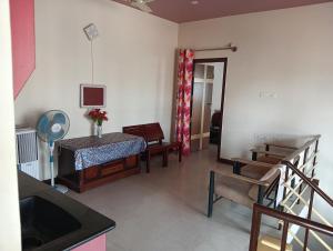 a room with a bed and a table and a mirror at MANTRAs in Mysore