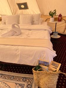 a bedroom with two beds and a basket on the floor at Quiet Nights Camp in Badīyah