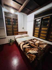 ein Schlafzimmer mit einem großen Bett in einem Zimmer mit Fenstern in der Unterkunft Idam Homestay - Entire 3 Bedroom Holiday Home in Idukki