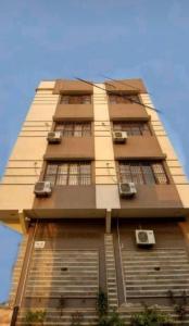 a tall building with windows on the side of it at Karachi inn Guest in Dargai