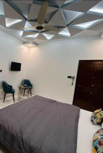 a bedroom with a ceiling fan and a bed at Karachi inn Guest in Dargai