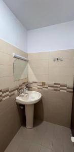 a bathroom with a sink and a mirror at Karachi inn Guest in Dargai