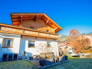 a house with a wooden roof at Cabin with sauna near Spieljoch Ski in Pankrazberg