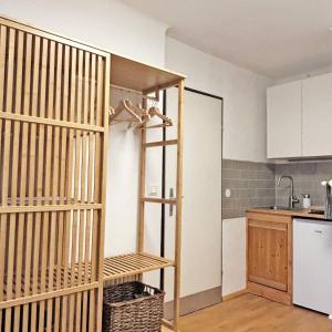 a kitchen with a book shelf in a room at Studio Homebase in Spittal an der Drau