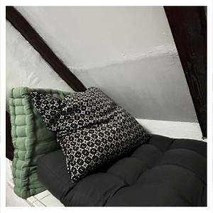 a black and white pillow sitting on top of a couch at Studio Homebase in Spittal an der Drau