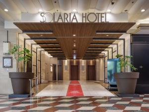 a lobby of a hotel with a red carpet at Solaria Nishitetsu Hotel Fukuoka in Fukuoka +112 photos